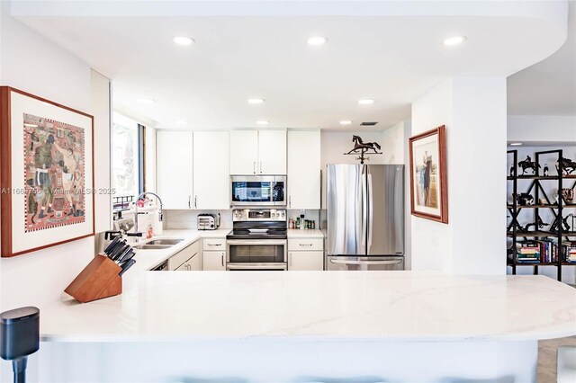 1586 S Ocean Ln Unit 125, Fort Lauderdale, FL 33316 - kitchen with stainless steel appliances, recessed lighting, a sink, and a peninsula
