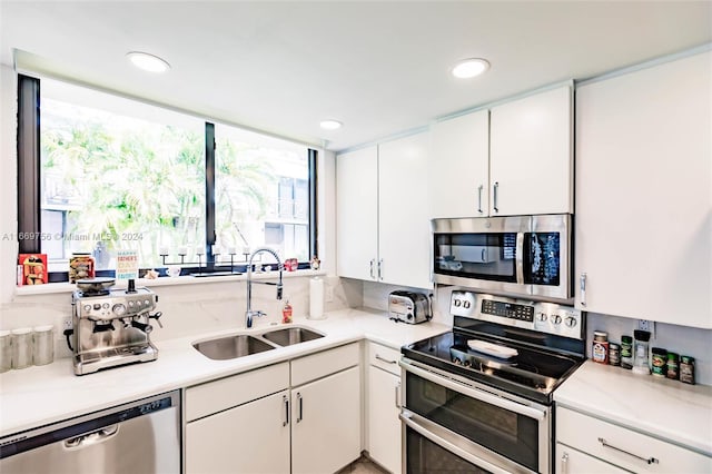 kitchen featuring white cabinets, sink, and appliances with stainless steel finishes