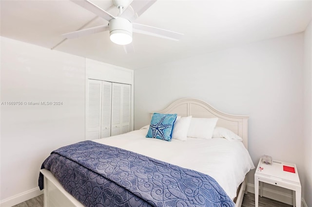 bedroom featuring ceiling fan, a closet, and hardwood / wood-style flooring