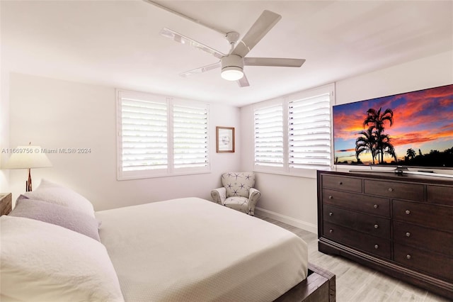 bedroom with ceiling fan and light hardwood / wood-style flooring