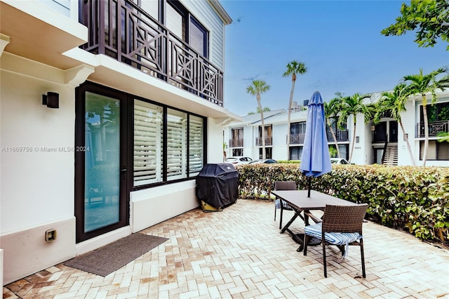 view of patio featuring grilling area and a balcony