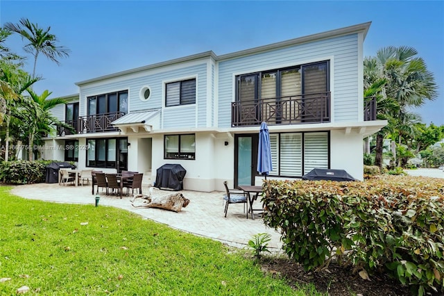 1586 S Ocean Ln Unit 125, Fort Lauderdale, FL 33316 - rear view of property with a lawn, a patio, a balcony, and stucco siding
