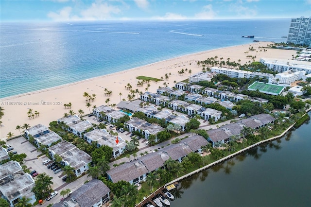 birds eye view of property featuring a beach view and a water view