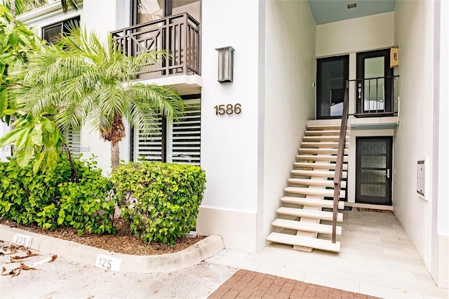 1586 S Ocean Ln Unit 125, Fort Lauderdale, FL 33316 - property entrance with a balcony and stucco siding