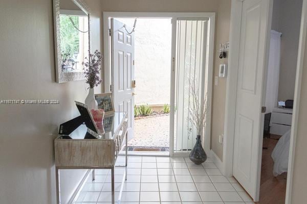 doorway with light tile patterned floors