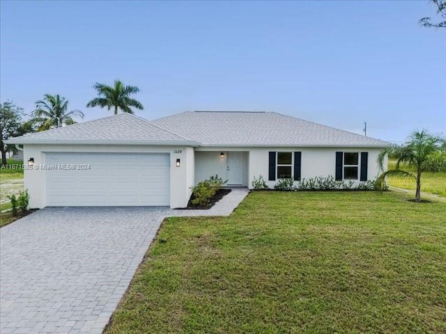 ranch-style home with a front lawn and a garage