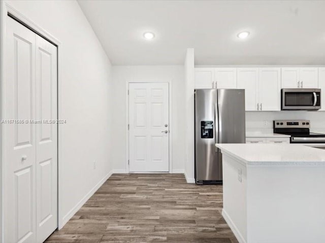 kitchen featuring white cabinetry, stainless steel appliances, and light hardwood / wood-style floors