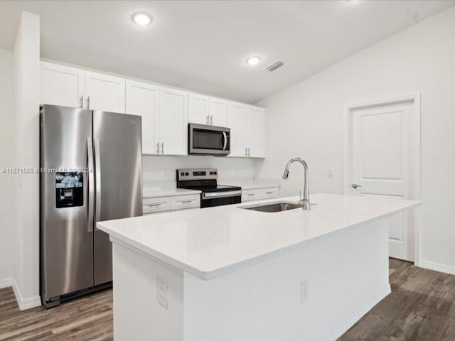 kitchen with white cabinets, stainless steel appliances, sink, and a kitchen island with sink