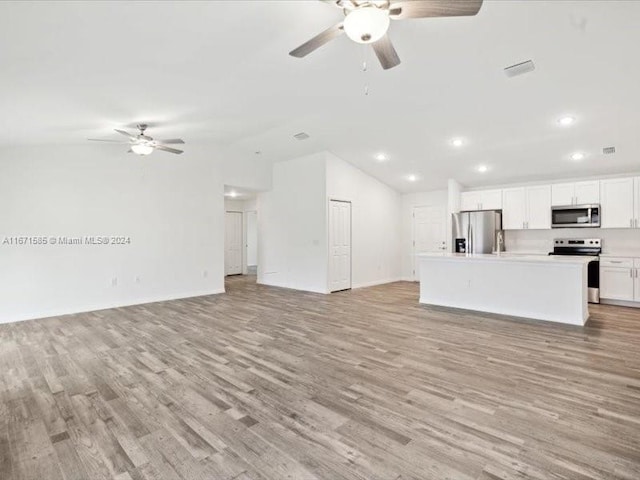 unfurnished living room with lofted ceiling, light hardwood / wood-style floors, and ceiling fan