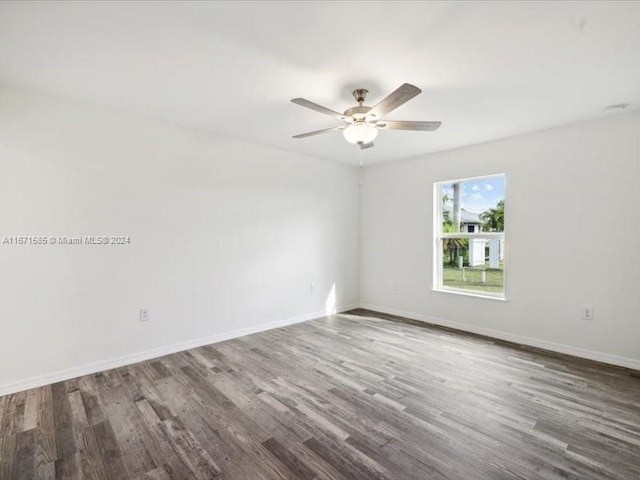 empty room with ceiling fan and hardwood / wood-style floors