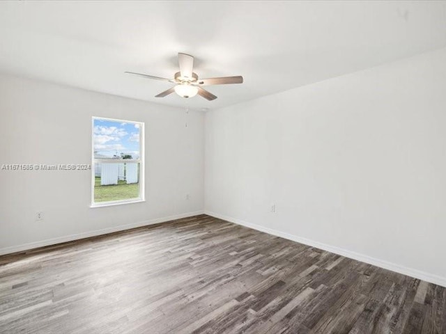 unfurnished room with dark hardwood / wood-style floors and ceiling fan