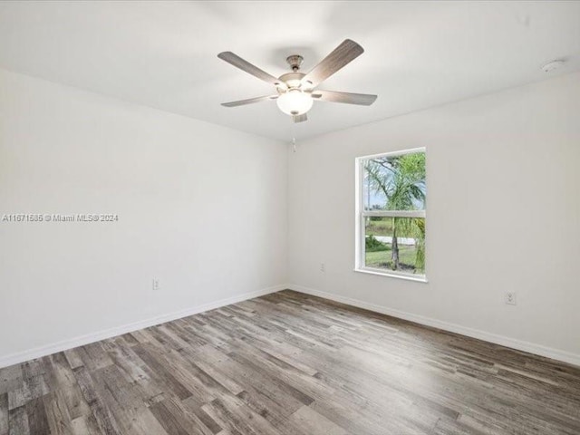 spare room featuring wood-type flooring and ceiling fan