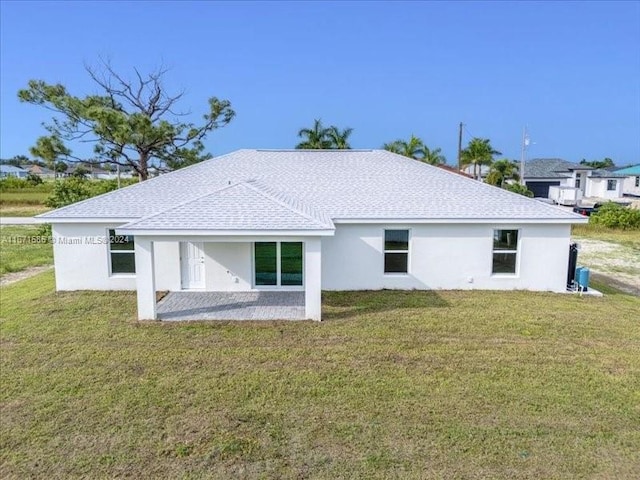 back of property featuring a lawn