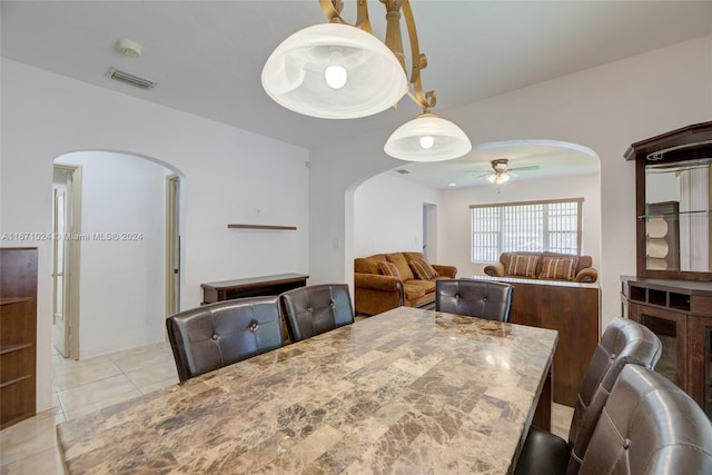 dining area featuring ceiling fan and light tile patterned floors