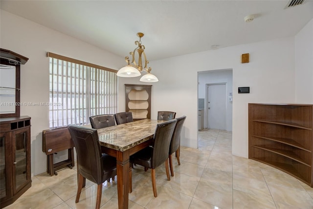 dining room featuring an inviting chandelier and light tile patterned floors