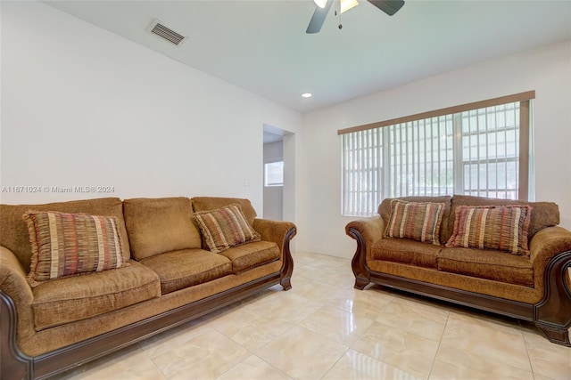 living room with ceiling fan and light tile patterned floors