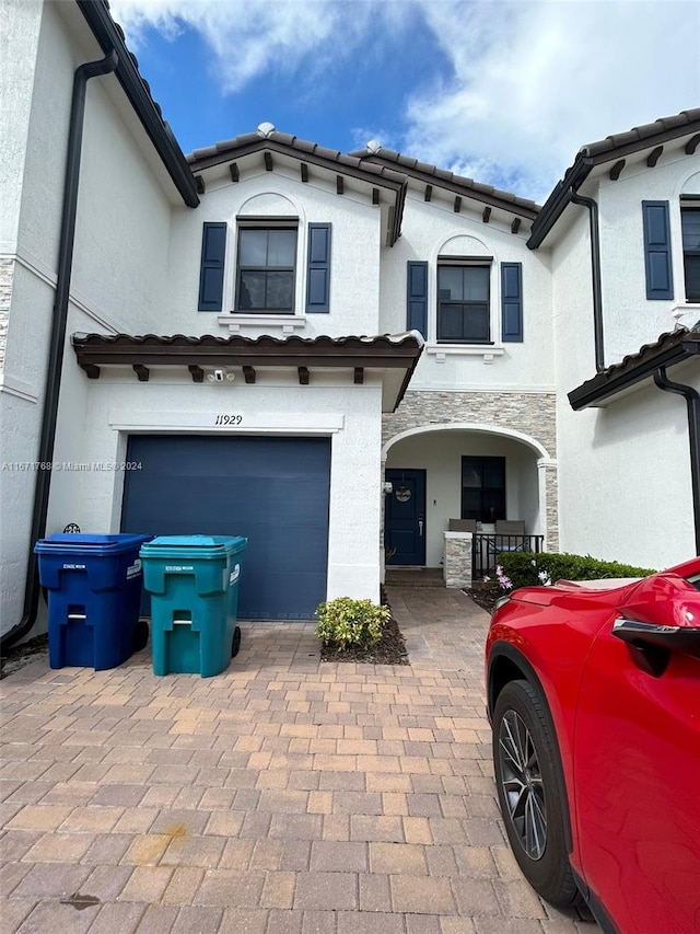 mediterranean / spanish home with a garage