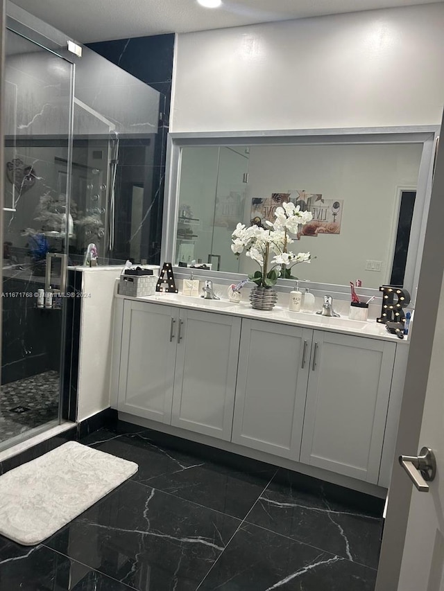 bathroom with vanity and a shower with shower door