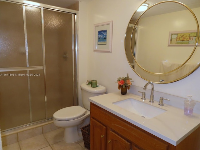 bathroom featuring walk in shower, vanity, toilet, and tile patterned floors