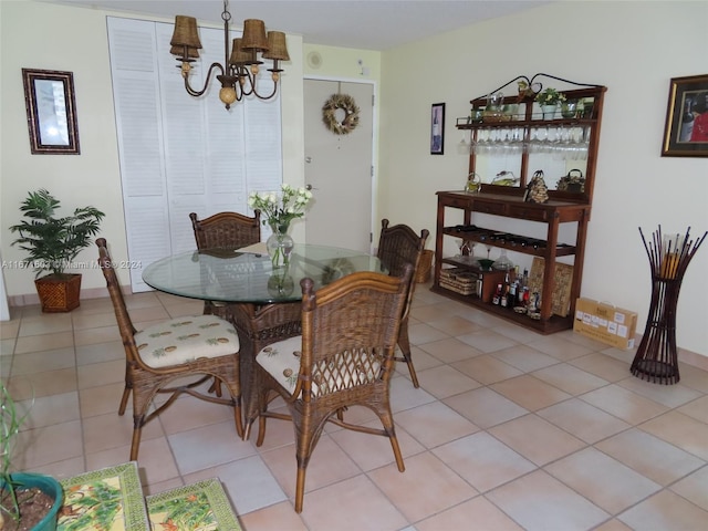 tiled dining area featuring a notable chandelier