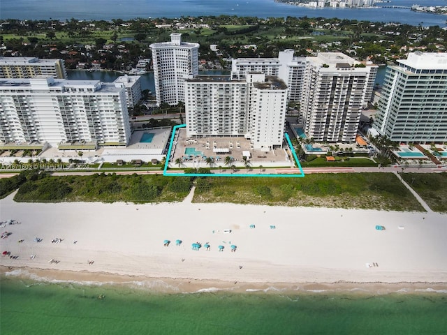 birds eye view of property with a view of the beach and a water view