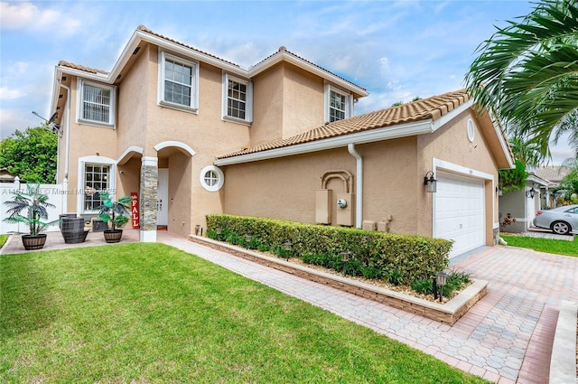 mediterranean / spanish-style home featuring a garage, a tiled roof, a front yard, and stucco siding