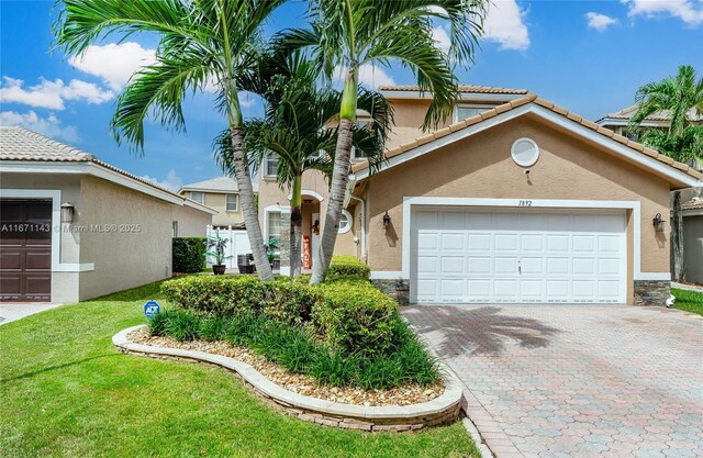 view of front facade with a front yard and a garage