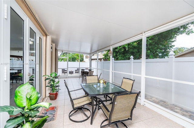 sunroom with outdoor dining space