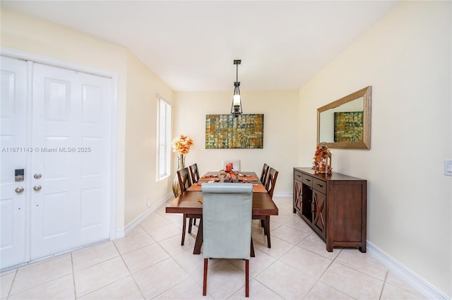 dining room with baseboards and light tile patterned floors