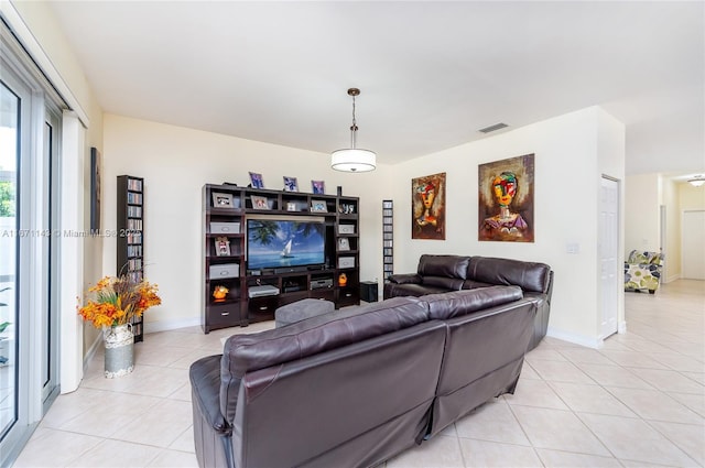 living area featuring light tile patterned floors and baseboards