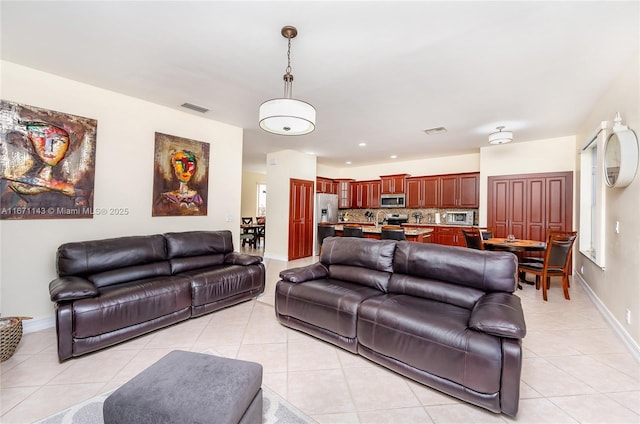 living room featuring light tile patterned floors and baseboards
