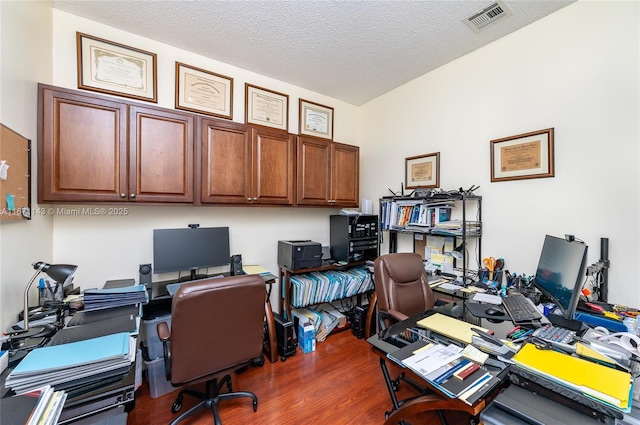 office space with dark wood-style flooring and a textured ceiling