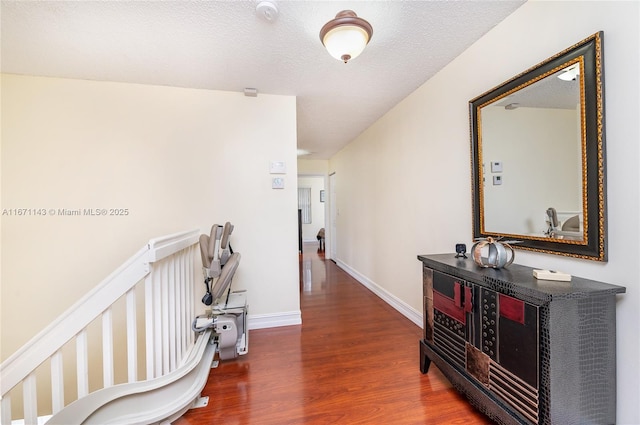 corridor featuring dark hardwood / wood-style floors and a textured ceiling