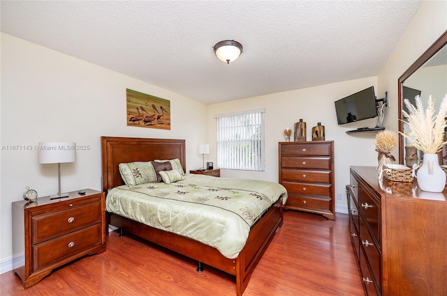 bedroom featuring dark wood-type flooring and a textured ceiling