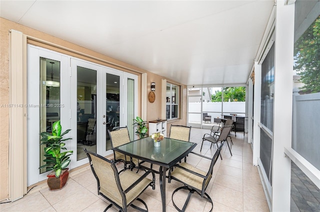 sunroom / solarium featuring french doors