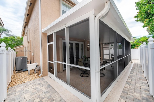 view of side of property with a sunroom and a patio