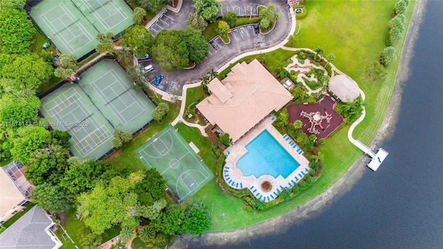 bird's eye view of a pool area and a large body of water