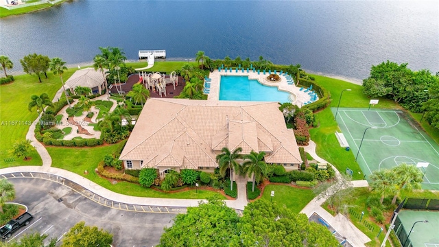 drone / aerial view of a pool and a large body of water