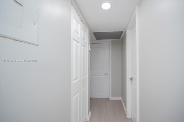 hallway with light hardwood / wood-style flooring