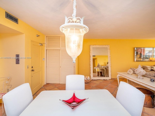 dining space with light tile patterned floors and a chandelier