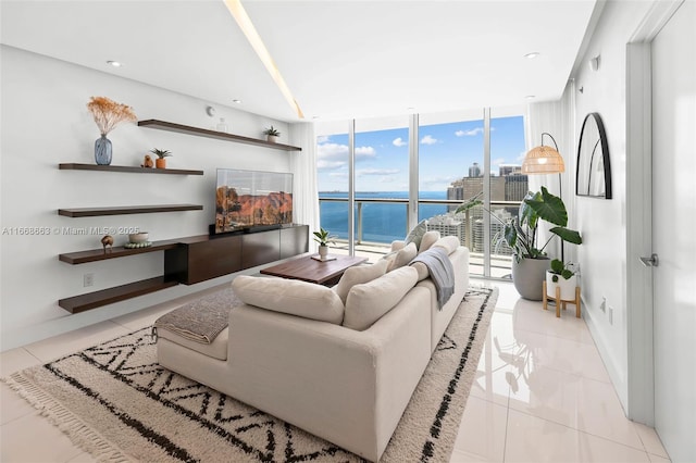 tiled living room with baseboards and floor to ceiling windows