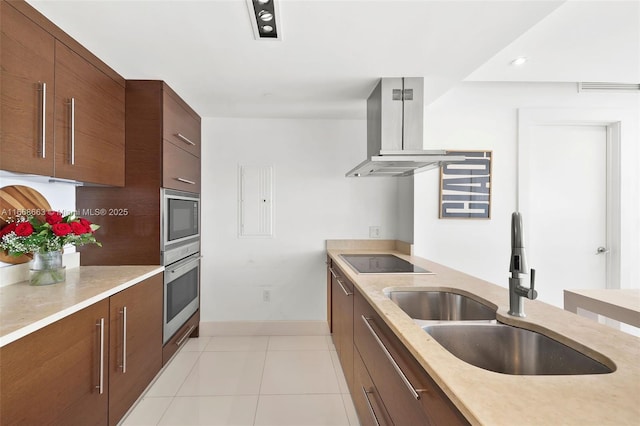 kitchen featuring modern cabinets, island exhaust hood, black electric cooktop, stainless steel oven, and a sink