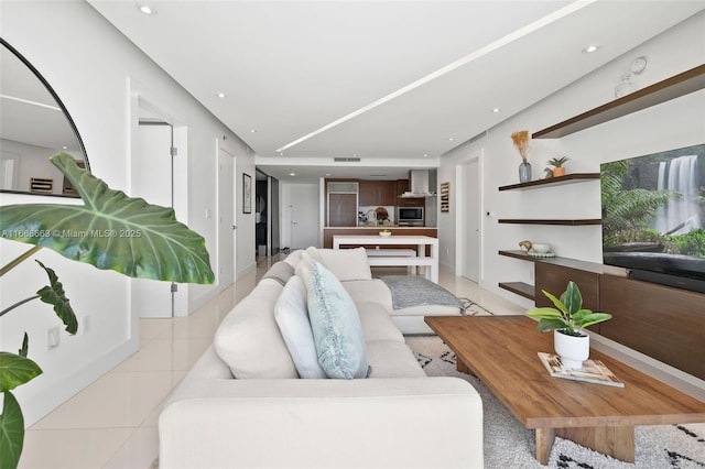 living area featuring light tile patterned floors and recessed lighting