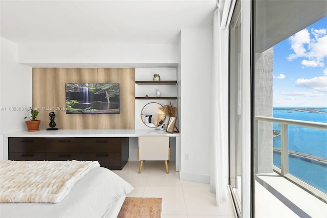 bedroom featuring a water view and light tile patterned floors