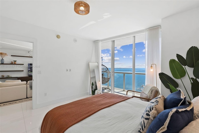 bedroom with tile patterned flooring, a water view, baseboards, access to exterior, and floor to ceiling windows