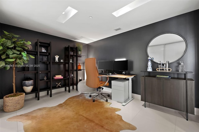 office area featuring a skylight, light tile patterned floors, and visible vents