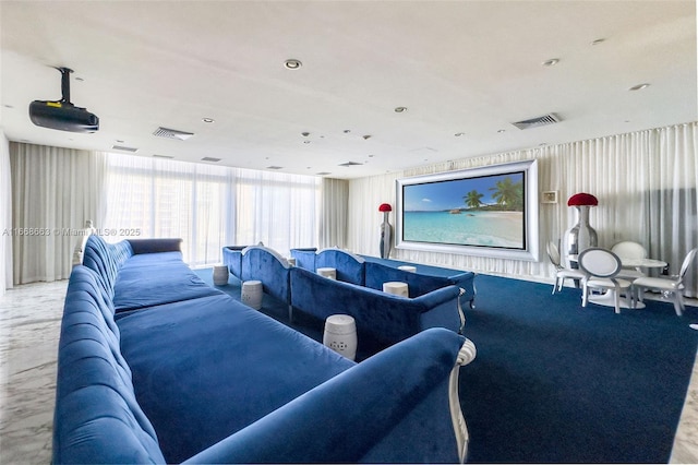 carpeted home theater room featuring visible vents