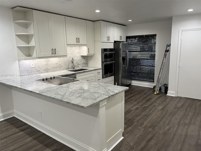 kitchen with kitchen peninsula, sink, dark wood-type flooring, and white cabinets