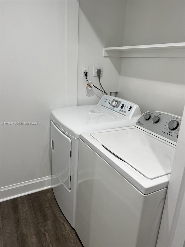 laundry area with dark hardwood / wood-style floors and independent washer and dryer