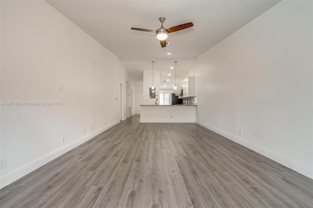 unfurnished living room featuring light wood-type flooring and ceiling fan